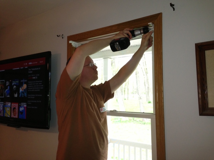 My husband putting up blinds.