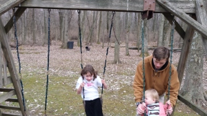 M being a nice big brother and pushing his sisters on the swings.